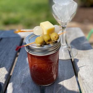 Bloody Mary in mason jar with olivces